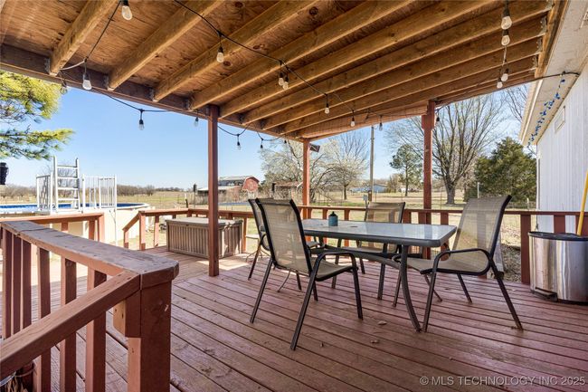 Large covered deck overlooking the pool | Image 36