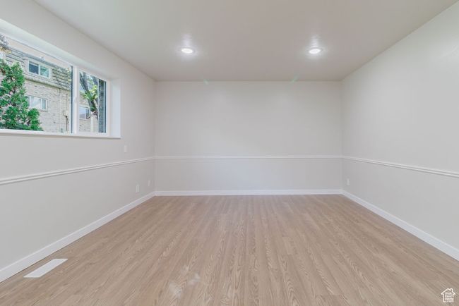 Spare room featuring light wood-style flooring, baseboards, and recessed lighting | Image 6