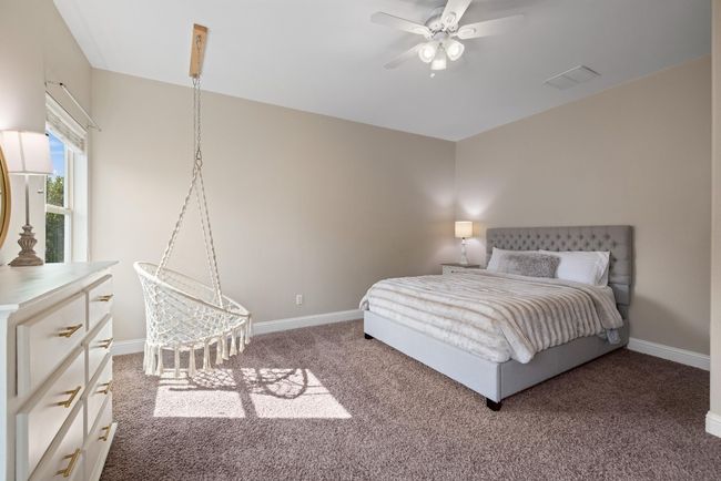 Bedroom with carpet floors, baseboards, ceiling fan, and visible vents | Image 34