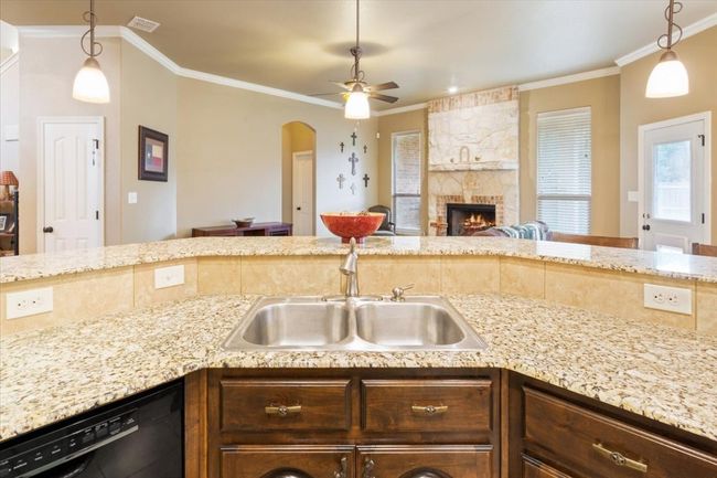 Kitchen with dishwasher, ornamental molding, ceiling fan, and a sink | Image 19