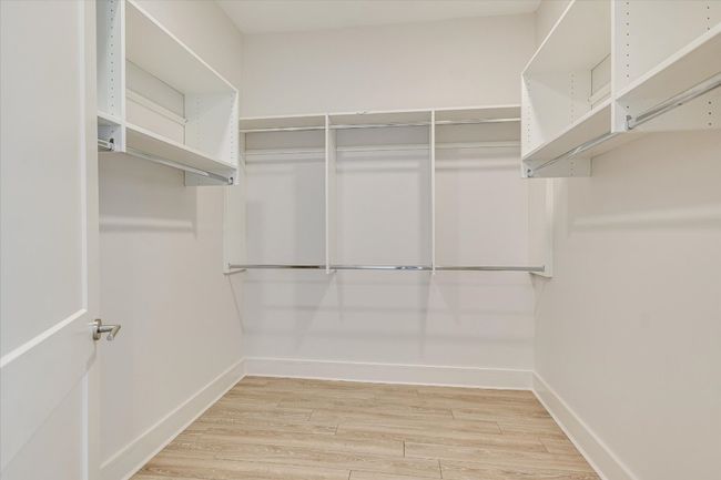 Walk in closet featuring wood finished floors | Image 14