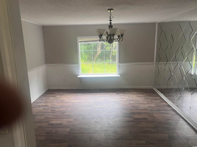 Unfurnished bedroom featuring dark wood-type flooring and baseboards | Image 12