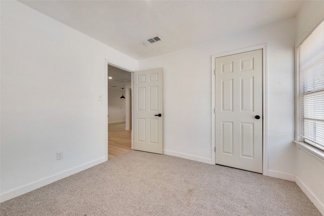 Unfurnished bedroom featuring baseboards, visible vents, and light colored carpet | Image 8