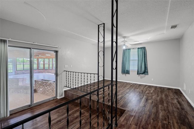 Corridor with plenty of natural light, an upstairs landing, visible vents, and wood finished floors | Image 27