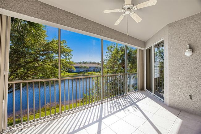 Unfurnished sunroom with a water view, plenty of natural light, and ceiling fan | Image 17