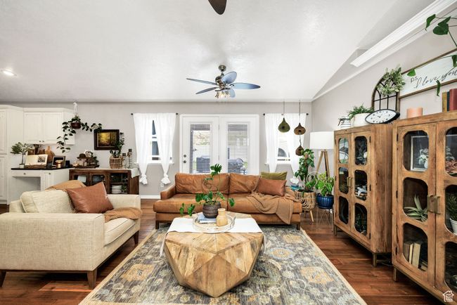 Living room featuring dark wood finished floors, ceiling fan, and lofted ceiling | Image 5