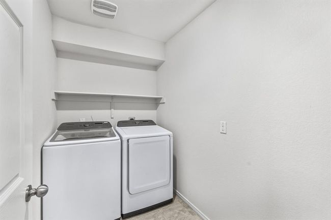 Laundry area with washing machine and clothes dryer and baseboards | Image 15