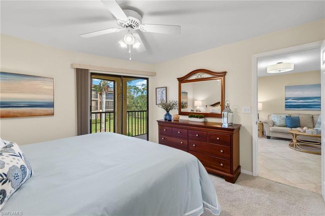 Carpeted bedroom featuring ceiling fan and access to exterior | Image 13