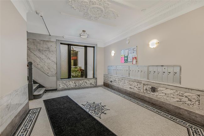 Hallway featuring mail area and crown molding | Image 5