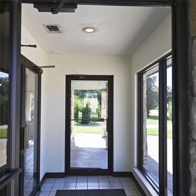 Doorway featuring tile patterned floors and a textured ceiling | Image 8