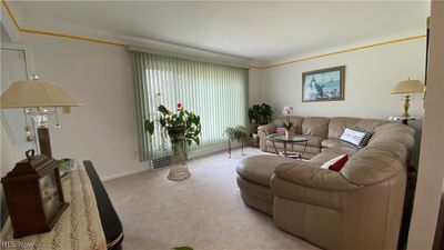 Carpeted living room with ornamental molding | Image 3