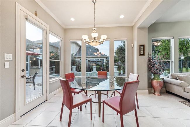 Breakfast nook right off the kitchen with a view of the pool for summer dreaming. Easily take your meal outside for an extension of your living space. | Image 12