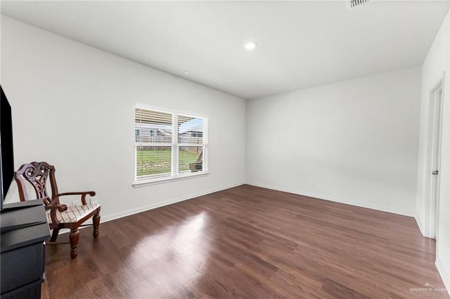 Unfurnished room with wood finished floors, baseboards, and recessed lighting | Image 12