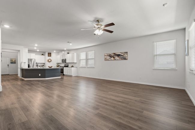 Open Concept Kitchen, Dining and Living room with ceiling fan, recessed lighting, dark wood finished floors, baseboards, and a sink | Image 12