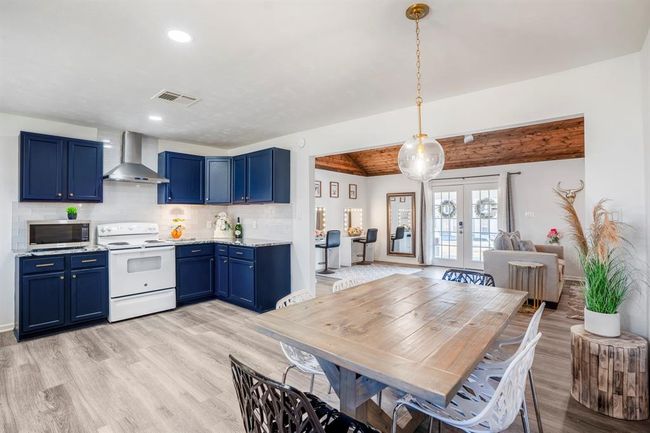 Kitchen, dining, and living spaces connect seamlessly—creating an open, inviting layout with easy flow to the covered porch and outdoor areas. | Image 15