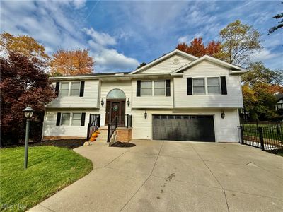 Split foyer home with a front yard and a garage | Image 2