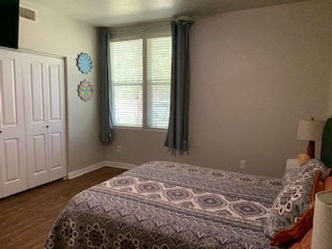 Bedroom featuring wood finished floors, baseboards, and a closet | Image 12