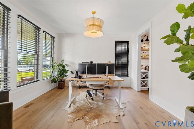 Office area with wood finished floors and baseboards | Image 11