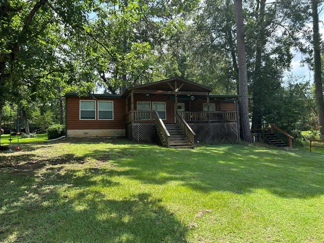 The property boasts 125 feet of bulkhead, a sturdy wood bulkhead, a private dock, and a boathouse with a Boat lift, ensuring effortless enjoyment of life on the water. | Image 4
