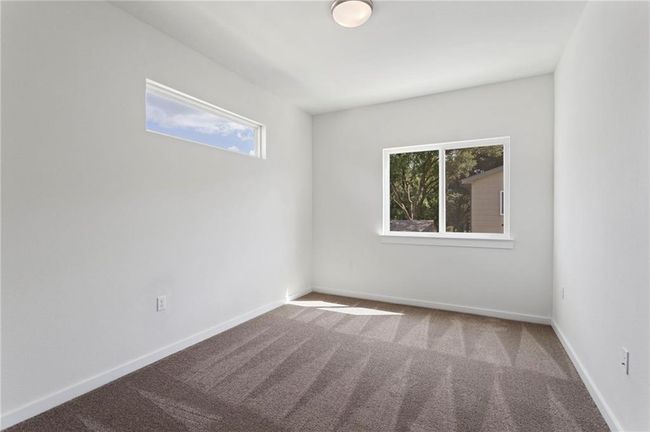 Unfurnished room featuring healthy amount of natural light and carpet flooring | Image 22