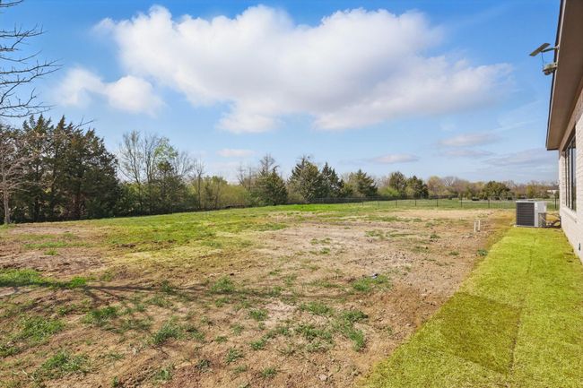 View of yard with central AC and a rural view | Image 38