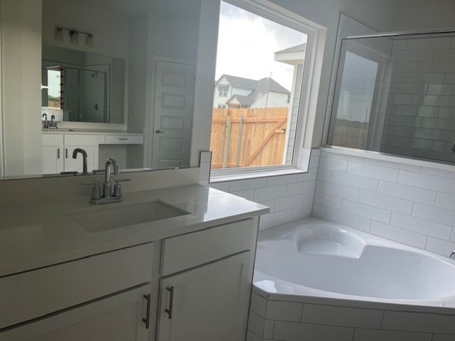 Full bath with a shower stall, vanity, and a garden tub | Image 7