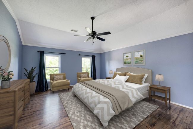 The primary suite has updated laminate floors and a raised ceiling. En-suite bath is to the right of the photo. Photo is virtually furnished. | Image 10