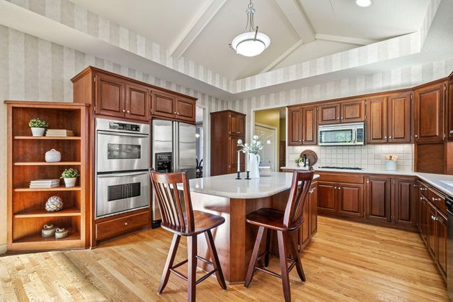 Spacious kitchen with cherry cabinets with double wall oven | Image 11
