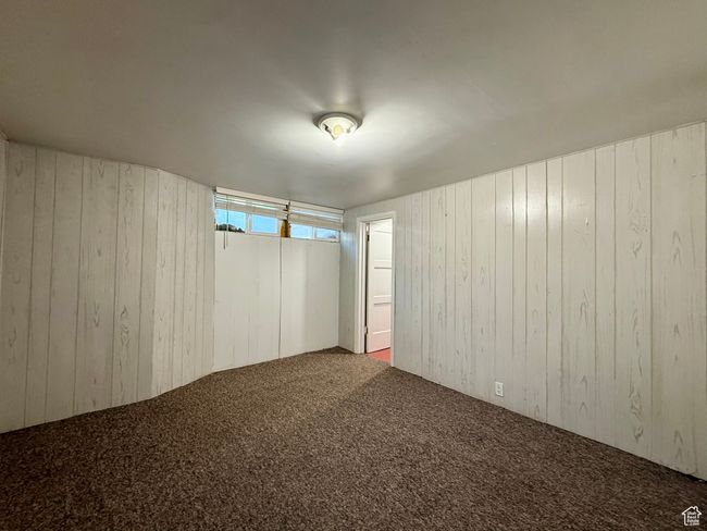 Unfurnished room featuring wooden walls and carpet | Image 34