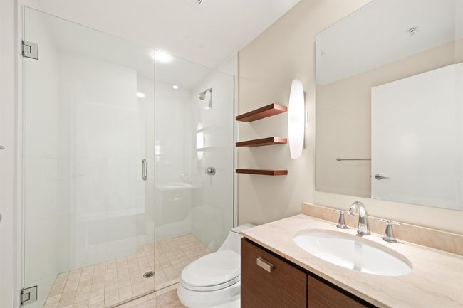 Full bathroom featuring a stall shower, vanity, and toilet | Image 9