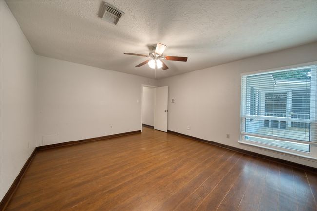 Primary bedroom with view of backyard | Image 18