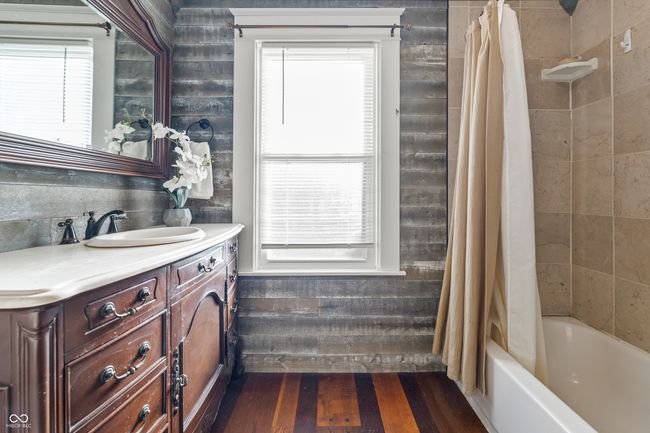 bathroom with vanity, shower / tub combo with curtain, plenty of natural light, and dark wood-style floors | Image 39