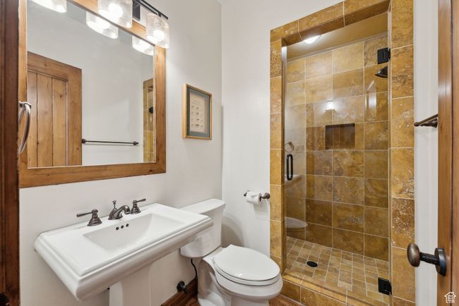 Full bathroom featuring a sink, toilet, and a shower stall | Image 25