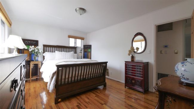 Bedroom with light wood finished floors and baseboards | Image 9