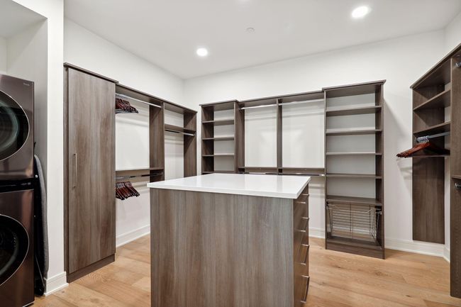 Amazing primary closet space with built-in components and laundry units | Image 22