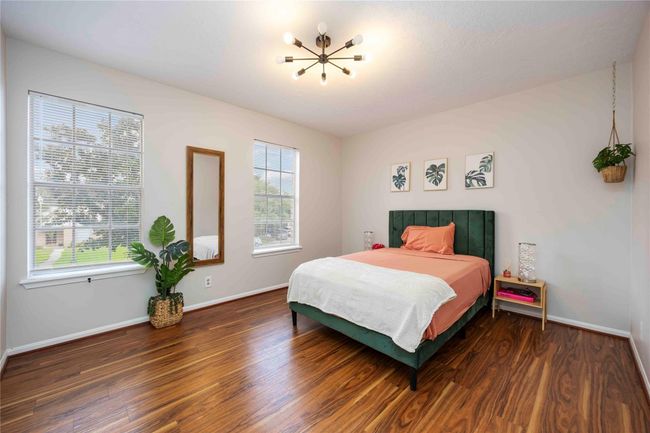 Another spacious second-floor bedroom featuring a walk-in closet and large windows that fill the room with natural light | Image 39