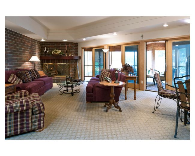 Lower level family room at the Mary Hill Lodge, complete with fireplace and screened-in wrap-around porch | Image 61