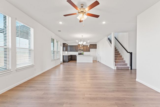 Unfurnished living room with stairway, recessed lighting, light wood-type flooring, and baseboards | Image 5