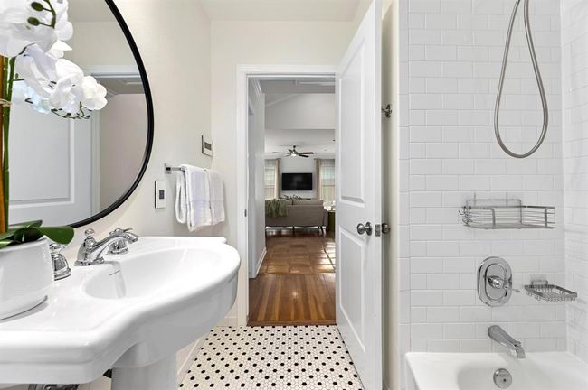 Ensuite bathroom featuring a ceiling fan, shower / tub combination, and tile patterned floors | Image 15