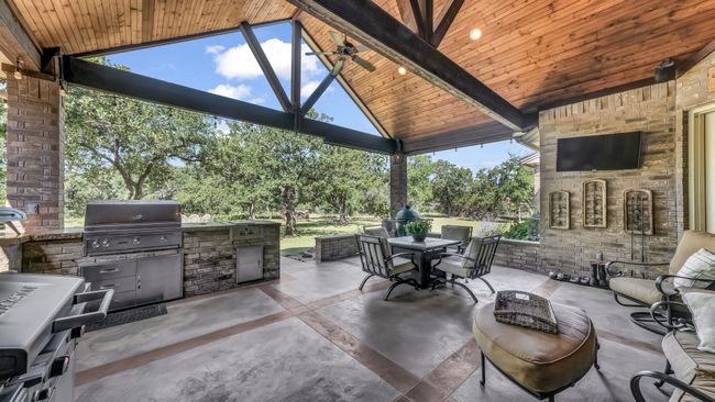 View of patio with an outdoor kitchen, outdoor dining area, and a gazebo | Image 37