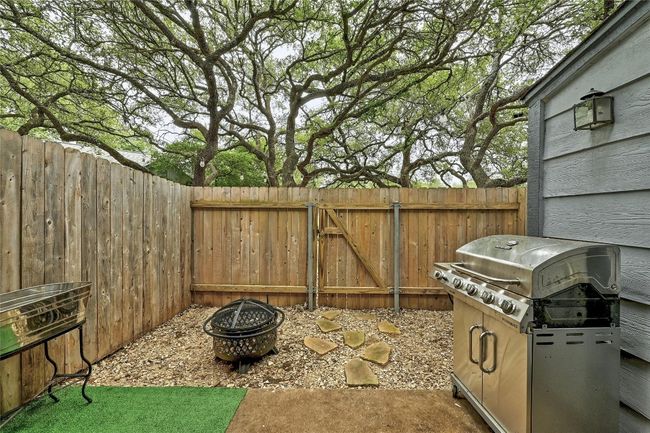 private back patio adorned with turf, providing a low-maintenance outdoor retreat | Image 19