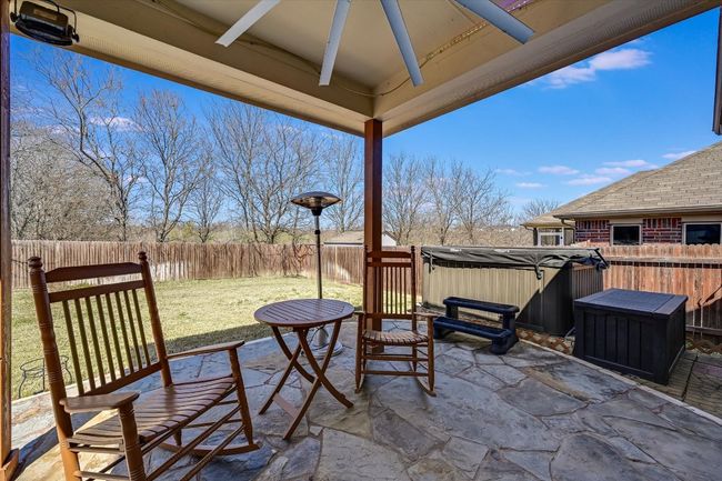 View of patio with a fenced backyard and a hot tub | Image 21