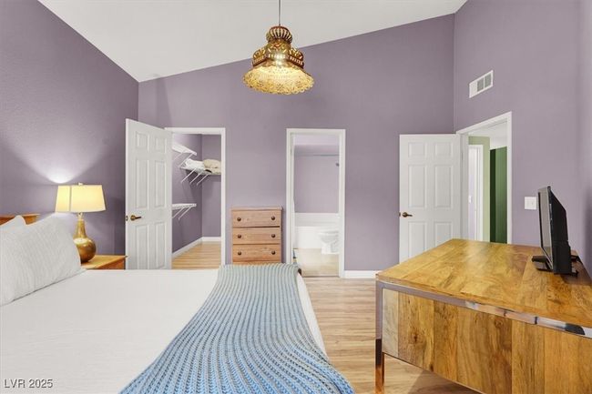 Bedroom featuring light wood-style flooring, visible vents, high vaulted ceiling, and baseboards | Image 20