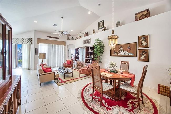 Living room featuring lofted ceiling and ceiling fan | Image 11