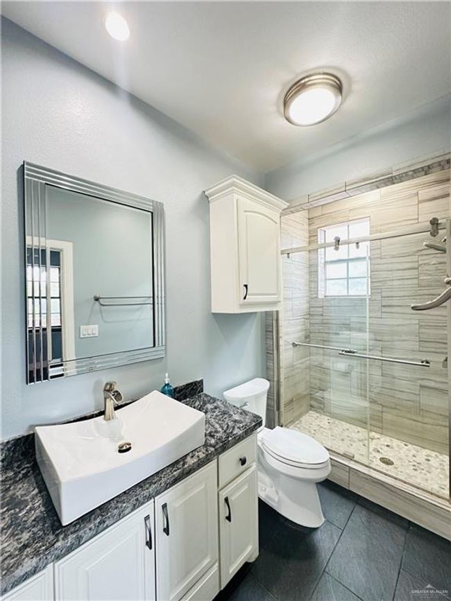 Bathroom featuring vanity and a shower stall | Image 20
