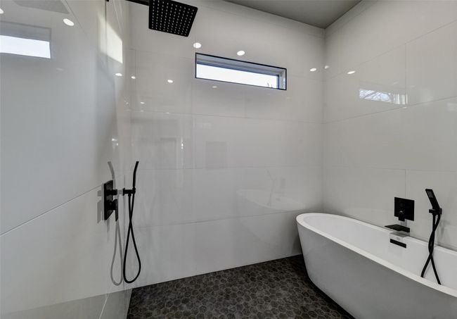 Bathroom with separate shower and tub and tile walls | Image 11