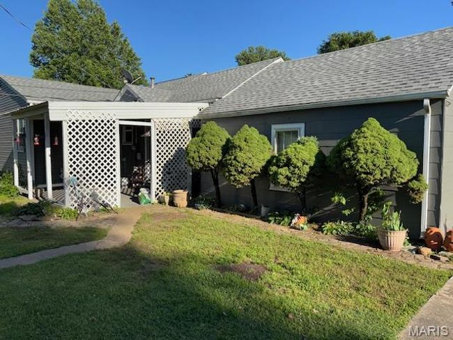 View of front of home with roof with shingles and a front lawn | Image 10