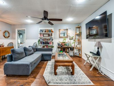 Living room with dark hardwood / wood-style flooring, ceiling fan, and a textured ceiling | Image 3