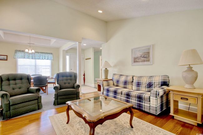 Living area with a chandelier, wood finished floors, and recessed lighting | Image 13