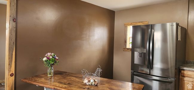 Kitchen with stainless steel refrigerator with ice dispenser | Image 15